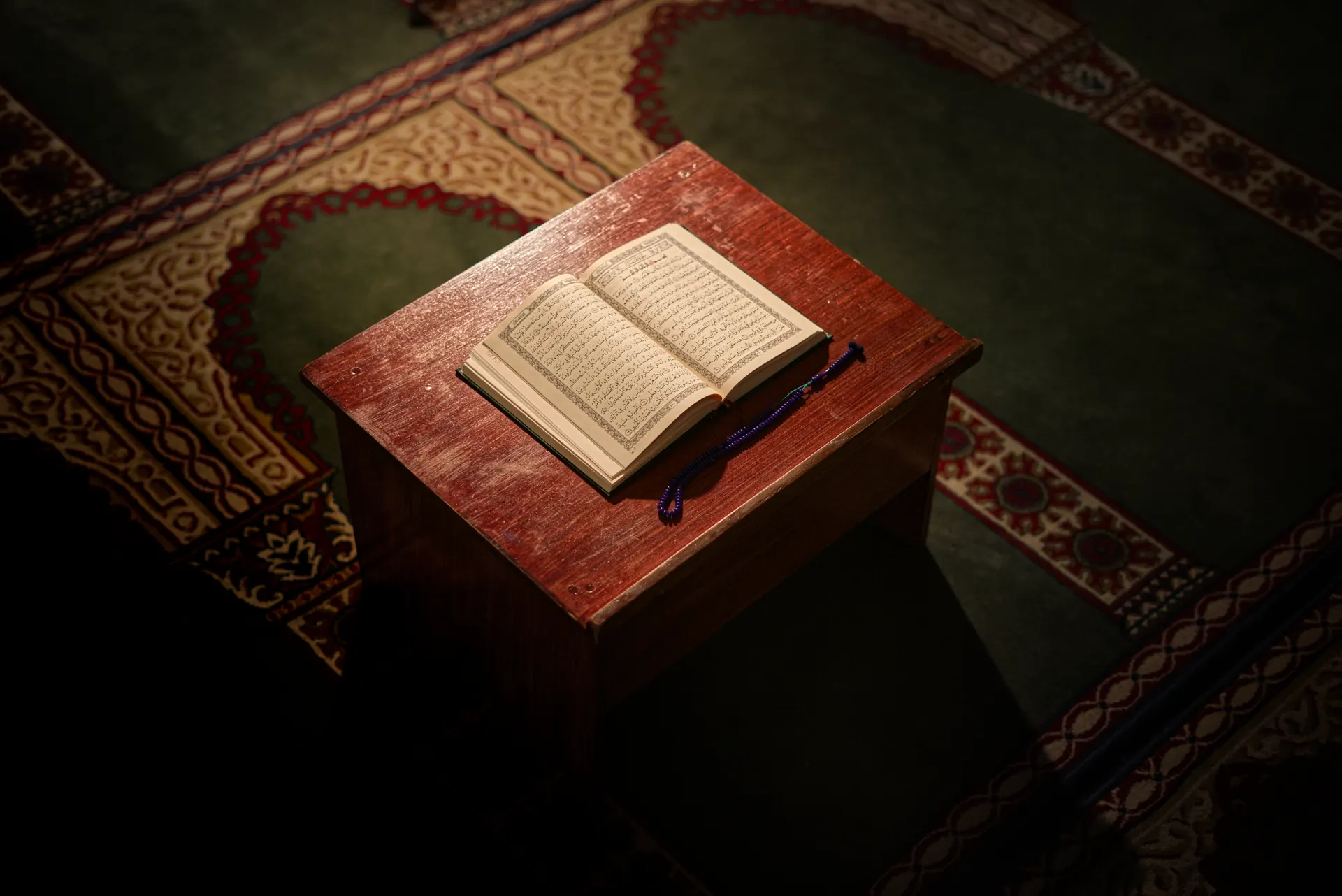 An open Qur'an resting respectfully on a wooden table at UMMA Centre